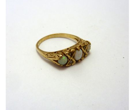 A 9CT GOLD OPAL RING, the three opals within a fancy scrolling mount to the plain tapered shank, ring size M 1/2