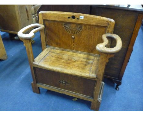 A SMALL OAK MONKS BENCH