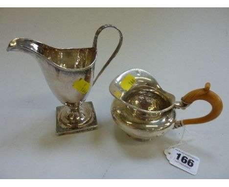 A GEORGE II SILVER HELMET FORM CREAM JUG, marks rubbed, together with a continental white metal cream jug (2)