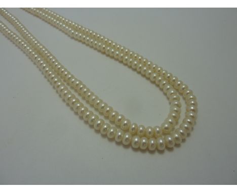 A FRESHWATER PEARL NECKLACE, comprising of two rows of pearls with a button shape 9ct gold clasp