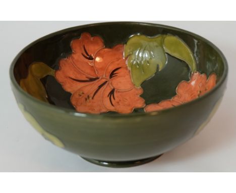 Moorcroft footed bowl decorated in the hibiscus design on green ground, diameter 16cm