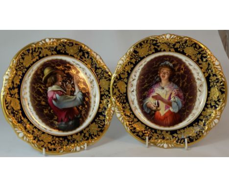 Pair Hammersley & Co gilded cabinets plates hand painted and transfer with Man smoking pipe and Woman with candle, diameter 2