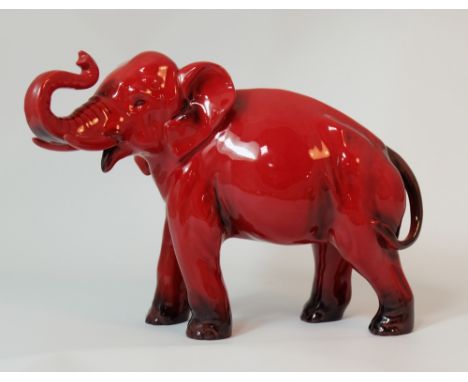 Royal Doulton Flambe Elephant with trunk in salute signed Noke, height 16.5cm