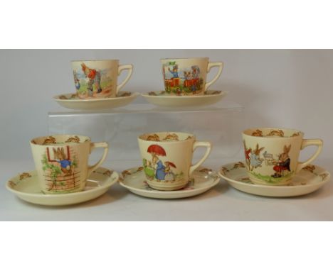 Royal Doulton early Bunnykins cups and saucers with various scenes,  signed by Barbarah Vernon (5)