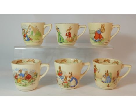Royal Doulton early Bunnykins cups with various scenes, some signed by Barbarah Vernon (6)