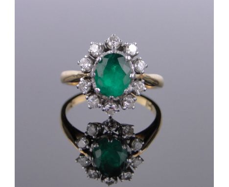 An 18ct gold emerald and diamond cluster ring,setting height 15mm, size Q.