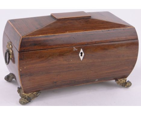 A 19th century rosewood sarcophagus shaped tea caddy,with fitted inner caddies and cast gilt metal feet, length 30cm.