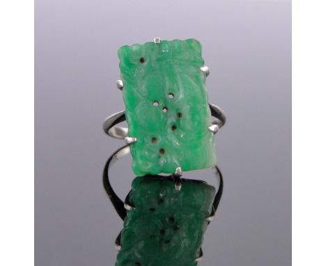 A Chinese carved and pierced jade panel ring circa 1920,indistinct marks tests as white gold, panel 19mm x 12mm, size K.