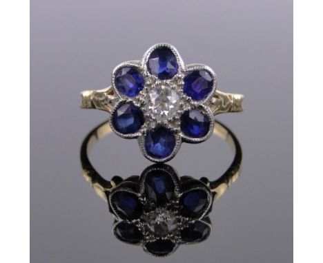 A sapphire and diamond set daisy head design cluster ring,unmarked gold settings, setting height 14mm, size R.