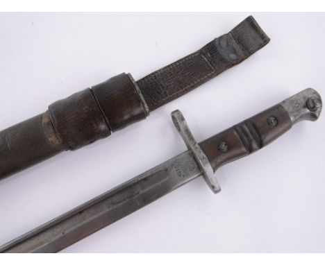 An American Remington First War period sword bayonet,dated 1913, blade length 43cm, original leather covered scabbard.