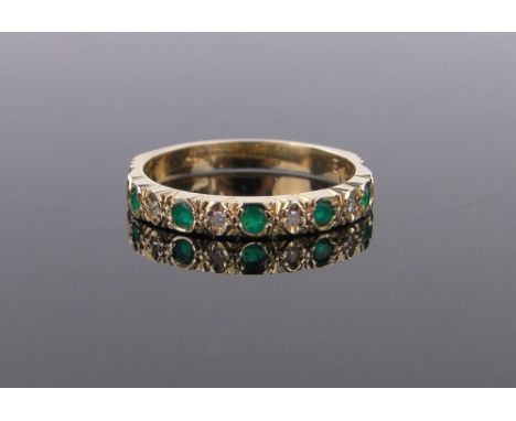 An 18ct gold emerald and diamond set half eternity ring,size N.