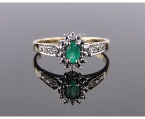 A 9ct gold emerald and diamond cluster ring,setting height 9mm, size N.