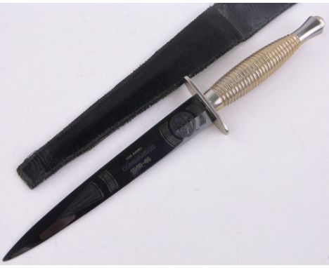 A modern Army Commando knife,with engraved blade, blade length 17.5 cm, leather pouch.