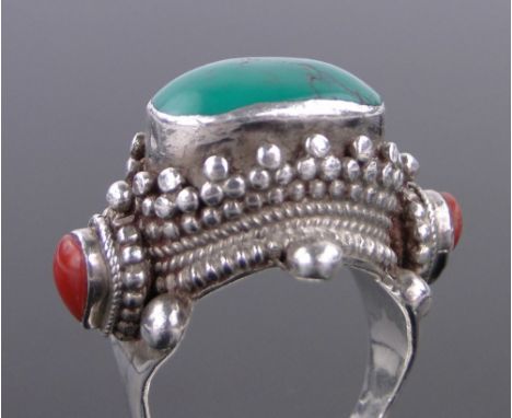 A South East Asian unmarked silver turquoise and coral set ring.**