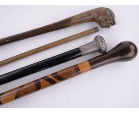 4 Various 19th century walking sticks,including a silver topped cane and a measuring stick, (4).