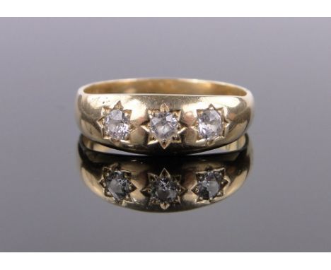 An 18ct gold 3 stone diamond set gypsy ring,size V, 6g.