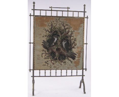 A Victorian brass framed firescreen,with inset beadwork owl design panel, height 93cm, width 62cm.