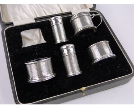 A 5-piece engine turned silver cruet set,with blue glass liners, Birmingham 1928.
