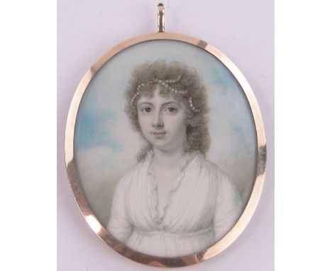 An early 19th century miniature watercolour on ivory portrait of a young woman,unsigned, in unmarked gold frame with hair pan