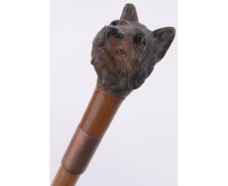 An unusual carved and painted wood tiger head design walking stick,with inset glass eyes.