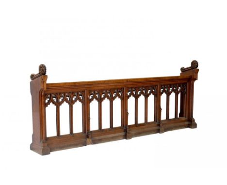 A VICTORIAN GOTHIC OAK CHOIR DESK, C1856-1878, with open arcaded front and foliate carved ends, 1126cm h; 38 x 285cmProvenanc