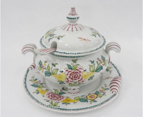 A PORTUGESE EARTHENWARE SOUP TUREEN, COVER, LADLE AND STAND, BOLDLY PAINTED WITH FLOWERS AND PICKED OUT IN PUCE, STAND 37CM O