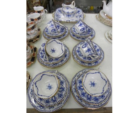 A COALPORT BLUE AND WHITE TEA SERVICE WITH GILT HANDLES AND GADROONED RIM, SERVICE INCLUDING A PAIR OF SHAPED SQUARE PLATES, 