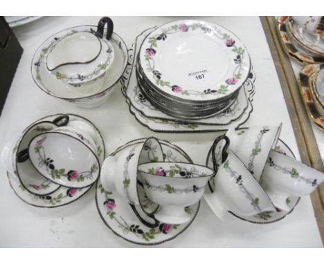 A SHELLEY BONE CHINA TEA SERVICE, DECORATED WITH ROSES, BLACK DENTIL RIMS AND HANDLES, THE SERVICE INCLUDING A PAIR OF SHAPED