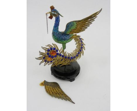 A SOUTH EAST ASIAN GILT SILVER COLOURED FILIGREE METAL AND TRANSLUCENT ENAMEL MODEL OF A PEACOCK, WOOD BASE, 18CM H, 20TH C, 