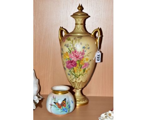 A ROYAL WORCESTER BLUSH IVORY TWIN HANDLED PEDESTAL COVERED VASE, floral decoration and gilt detailings, puce backstamp and N