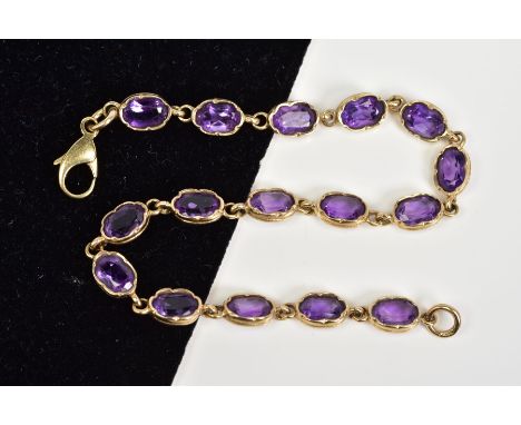 A 9CT GOLD AMETHYST SET BRACELET, designed with sixteen oval cut amethyst links within collet mounts and lobster claw clasp, 
