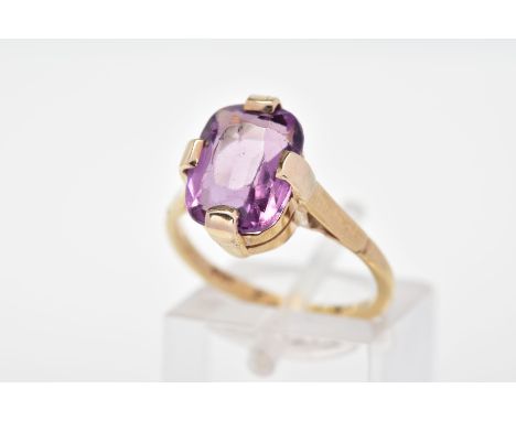 A PURPLE PASTE RING, designed with a cushion shape purple paste in a four claw setting to the plain polished band, ring size 