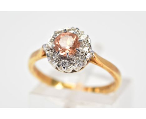 AN 18CT GOLD TOPAZ AND DIAMOND CLUSTER RING, designed with a central circular cut orange/pink topaz with a round brilliant cu