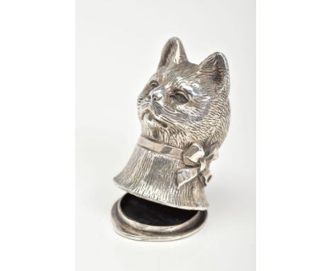 A CAT VESTA CASE, designed as a cat head with a ribbon round its neck, to the hinged base with scrolling decoration to the ba