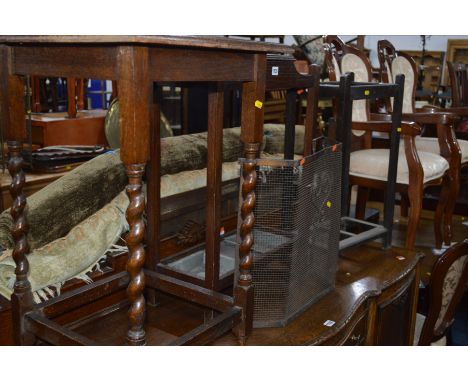 AN OAK UMBRELLA STAND with two tin inserts together with another umbrella stand, an occasional table and a fire screen (4)