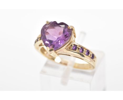 A 9CT GOLD AMETHYST RING, the heart shape amethyst within a three claw setting to the amethyst set shoulders, with a 9ct hall