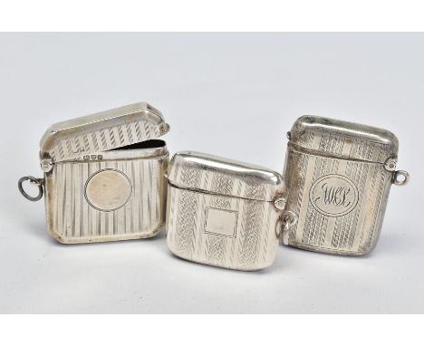 THREE EDWARDIAN/GEORGE V SILVER RECTANGULAR VESTA CASES, all with engine turned decoration, one engraved with initials to the
