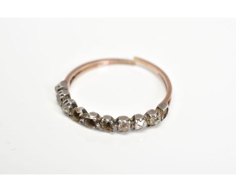 A LATE GEORGIAN DIAMOND HALF ETERNITY RING, with closed back settings for ten diamonds, set with six old cut diamonds (condit