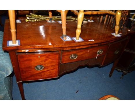 AN EARLY 19TH CENTURY MAHOGANY AND INLAID BOW FRONT SIDEBOARD, fitted with a single drawer above a reeded wavy apron, flanked