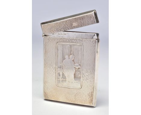 AN EDWARDIAN SILVER CARD CASE OF RECTANGULAR FORM, textured finish surrounding a vacant shield shaped cartouche and a couple 