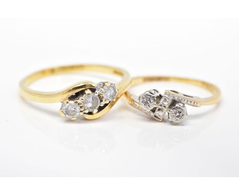 TWO DIAMOND SET RINGS, the first of crossover design set with three round brilliant cut diamonds, stamped diamond weight 50pt