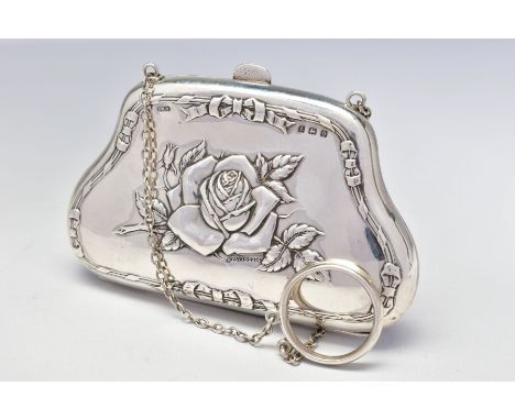 A GEORGE V SILVER PURSE, repousse decorated with roses and ribbons to both sides, on a chain with finger ring, leather lined 