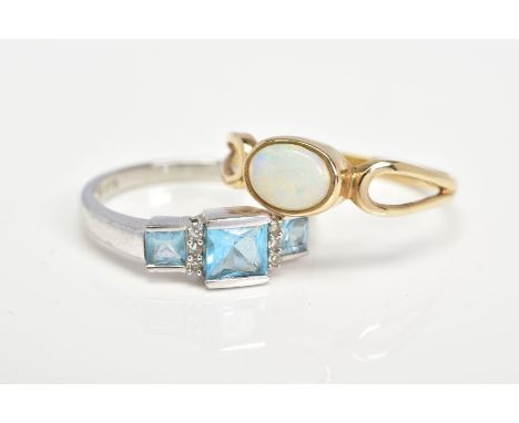 TWO 9CT GOLD GEM SET RINGS, the first designed with a central oval opal cabochon in collet mount to the openwork shoulders, r