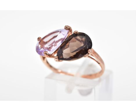 A 9CT GOLD GEM SET RING, designed with a pear cut smoky quartz and amethyst to the plain polished band, with a 9ct hallmark f