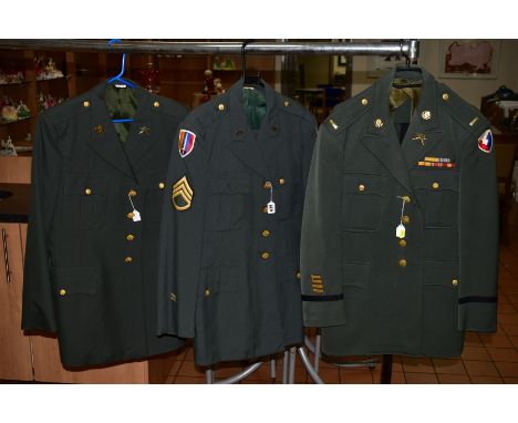 THREE ITEMS OF US FORCES WWII ERA UNIFORMS, two jackets and trousers, uniform caps with Eagle badges, rank badges medal ribbo