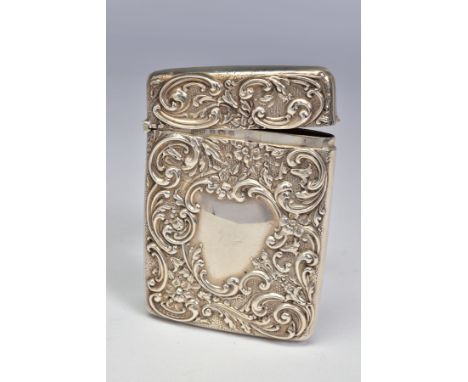 AN EDWARDIAN SILVER CARD CASE OF RECTANGULAR FORM, repousse decorated with foliate scrolls, vacant cartouches back and front,