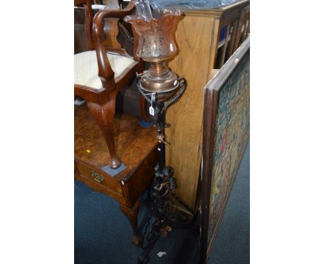 AN ART NOUVEAU BRASS AND WROUGHT IRON TELESCOPIC OIL LAMP with a etched glass shade, height 154cm