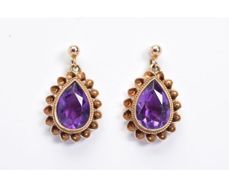 A PAIR OF 9CT GOLD AMETHYST DROP EARRINGS, each designed as a pear shape amethyst within a double rope twist surround suspend