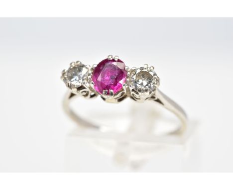 A RUBY AND DIAMOND RING, set with a central oval cut ruby flanked with brilliant cut diamonds, within an open work gallery, e