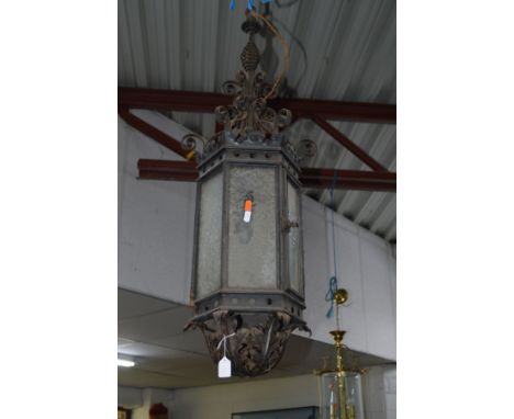 AN EARLY 20TH CENTURY FOLIATE WROUGHT IRON HEXAGONAL HANGING LANTERN, height 89cm